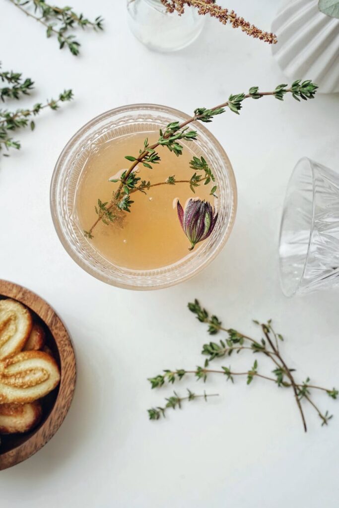 clear glass bowl with herbs and tea