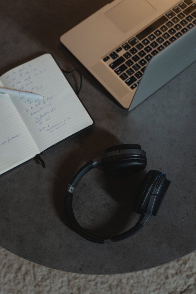 black headphones beside the laptop