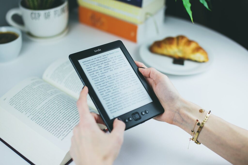 person holding kindle e book reader