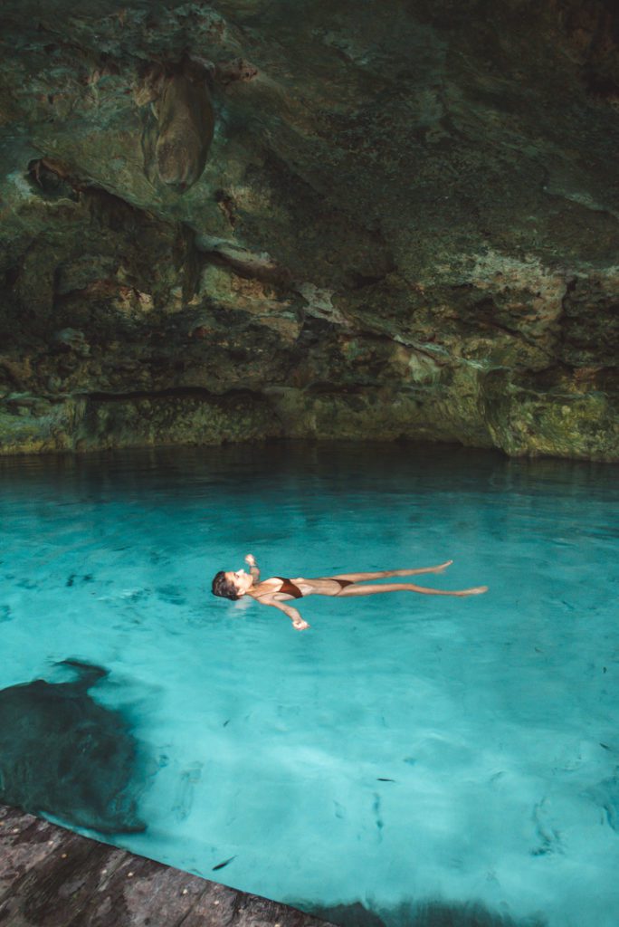 Floating in the clear water of Cenote Dos Ojos Mexico