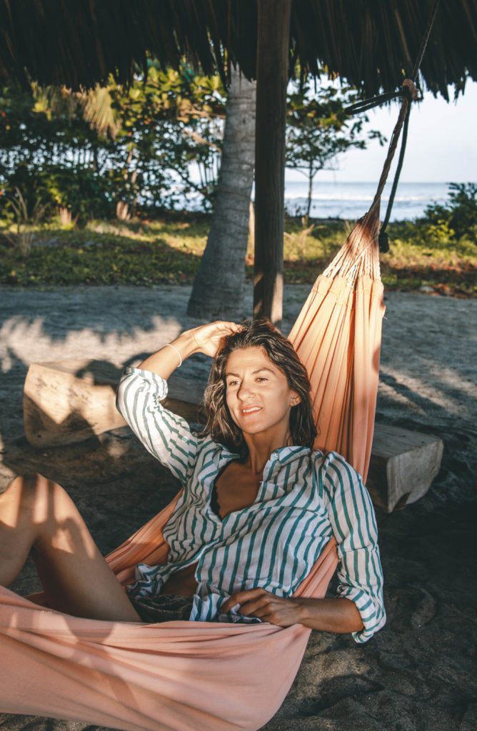 Woman relaxing on a hammock on the beach