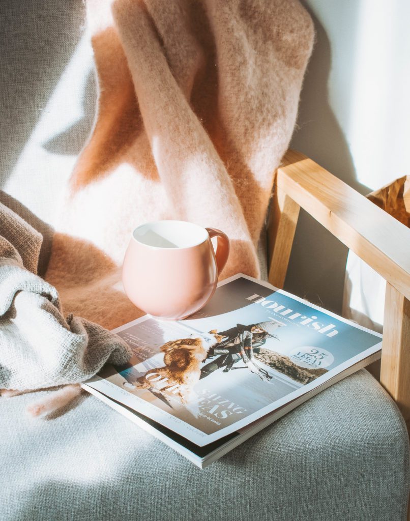 magazine and mug - why traveling is important for mental health