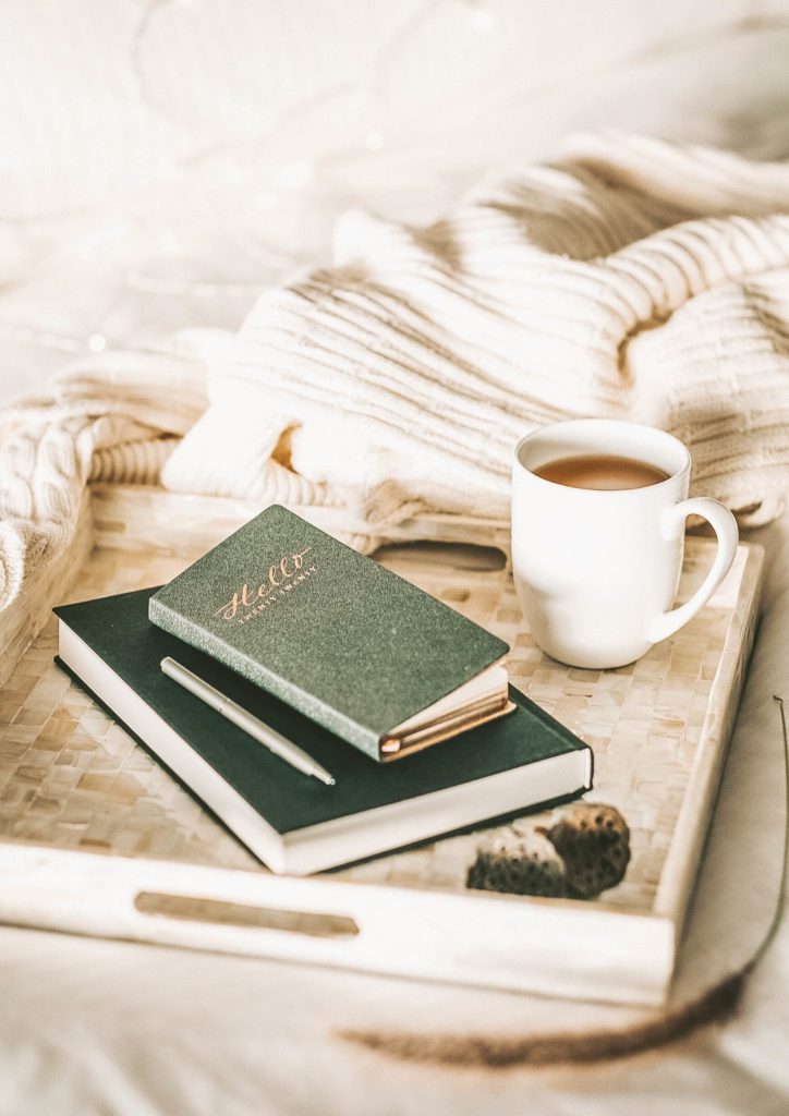 books with tea in bed- why traveling is important for mental health