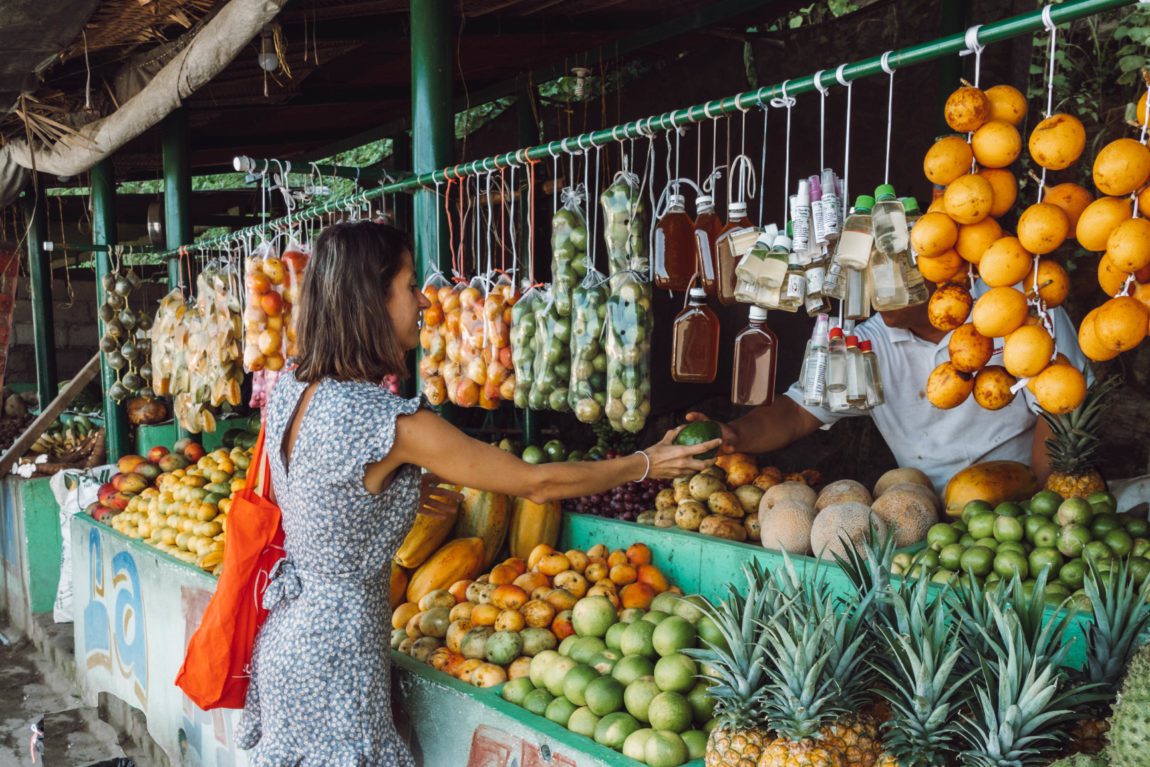 woman in a market traveling as a vegan