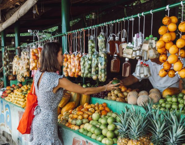 woman in a market traveling as a vegan