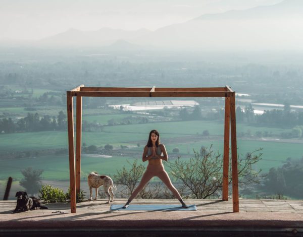 woman doing yoga on a deck with a view