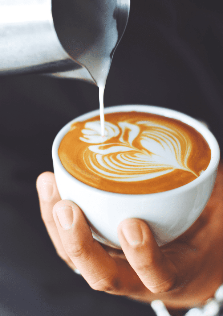 pouring milk into a coffee all natural energy booster