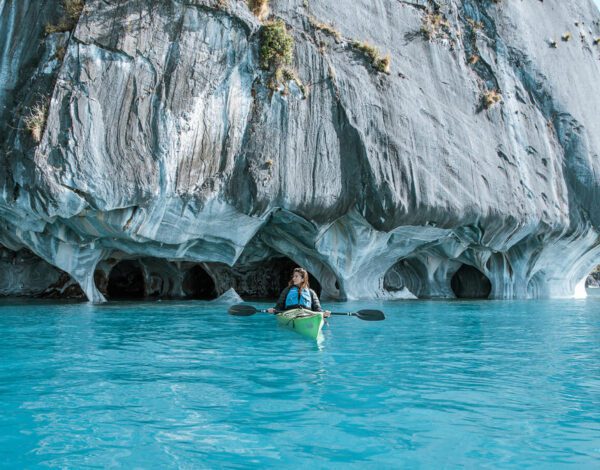 woman kayaking in the Marble Caves pinterest pin