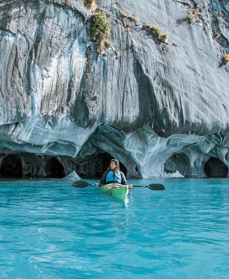 woman kayaking in the Marble Caves pinterest pin