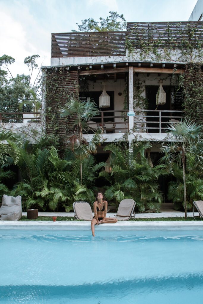 Woman by pool at boho hotel in Tulum