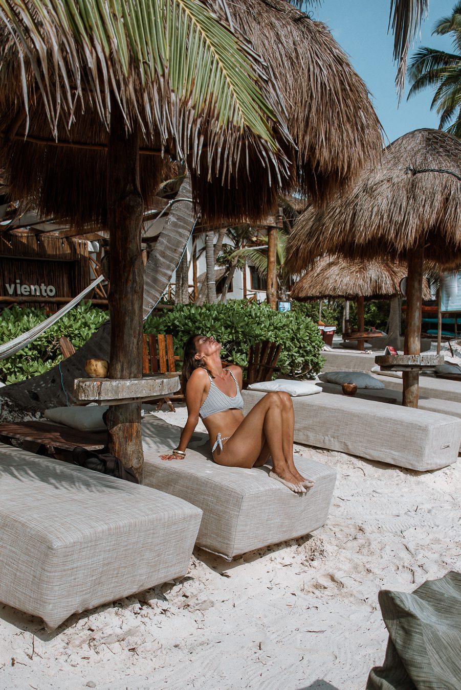 Woman at a beach club in Tulum where to stay in Tulum