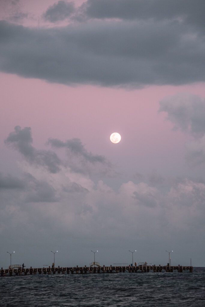 moon rise over pier in Playa del Carmen, Mexico