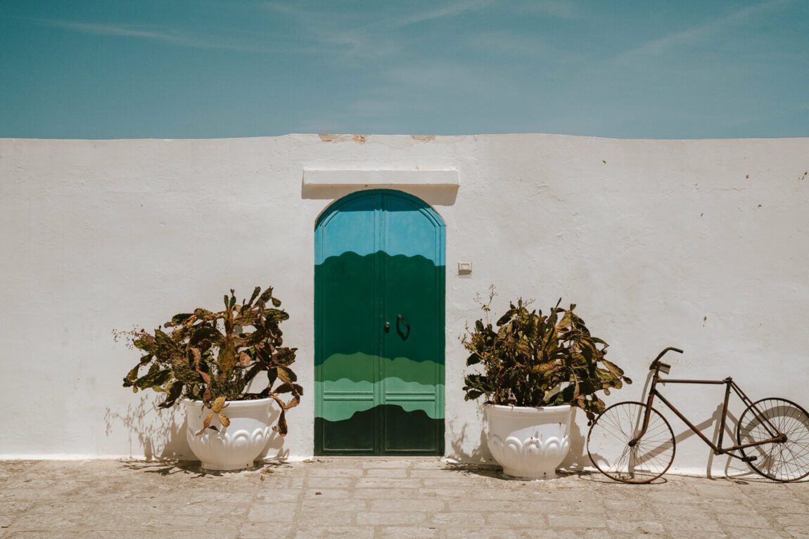 colorful door against a white wall in ostuni Italy