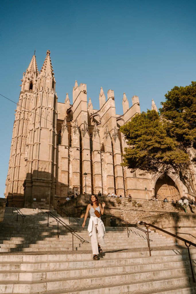 woman walking down the stars of Palma Cathedral