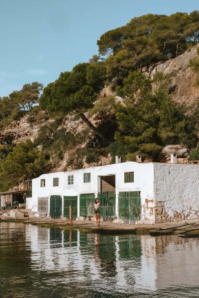 Womon and boathouses on Cala Pi, Mallorca