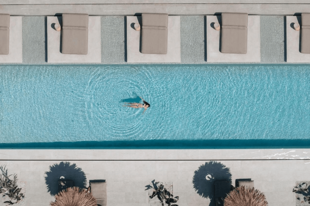 woman swimming in a pool at a luxury hotel in Paros Greece