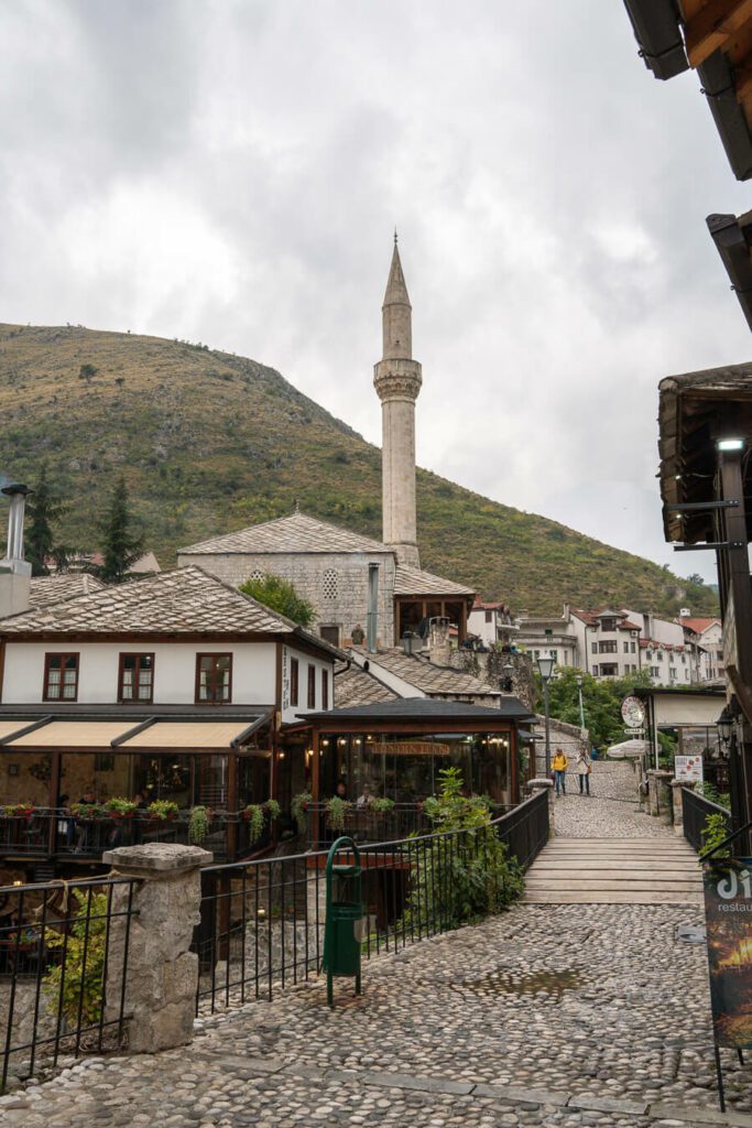 stone street with mosque and minaret in Mostar, Bosnia