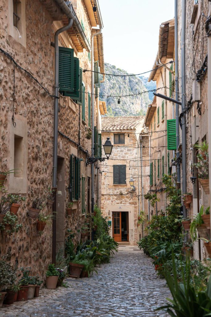 a street with stone buildings in Valldemossa Mallorca