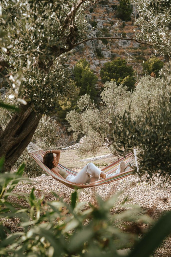 woman in a hammock around olive groves in Mallorca