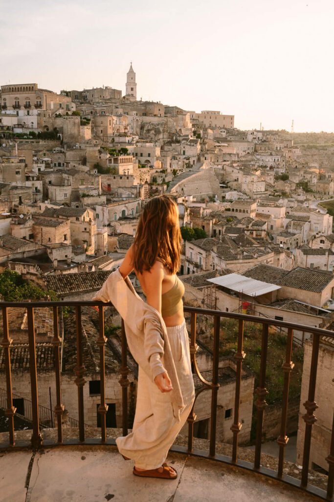 woman enjoying the sunrise in Matera, Italy