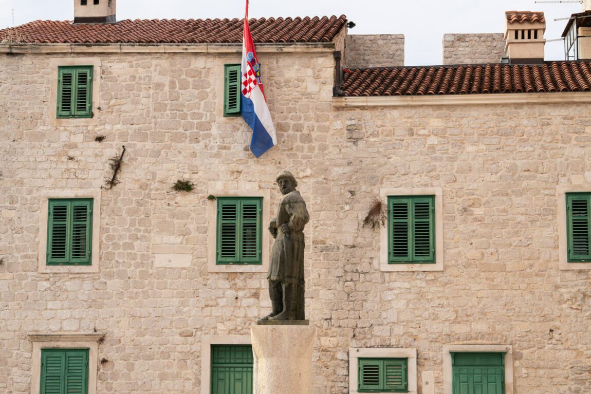 Statue and stone building in Sibenik Croatia