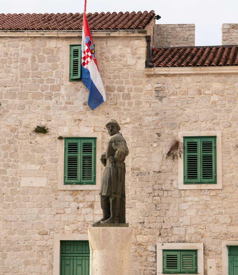 Statue and stone building in Sibenik Croatia