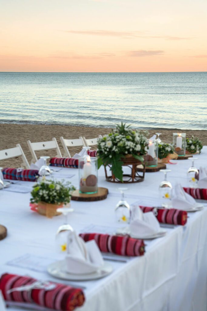 decorated aesthetic dinner table on the beach at sunset in Hua Hin thailand