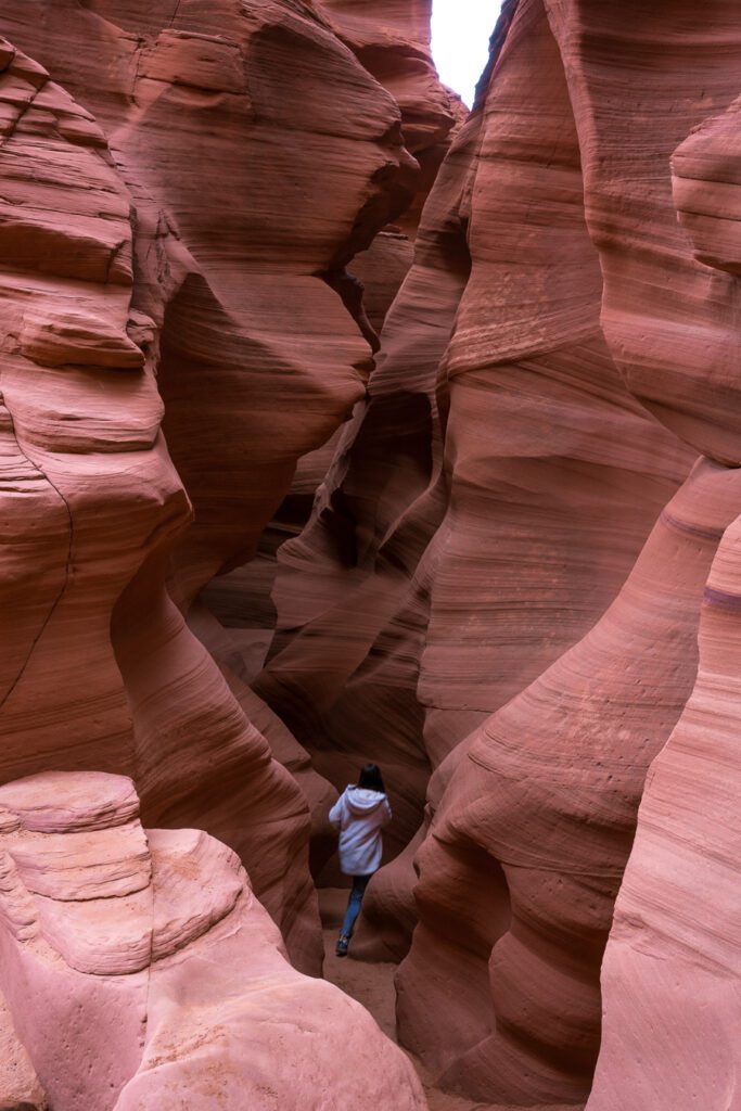 woman walking through Antelope Canyon