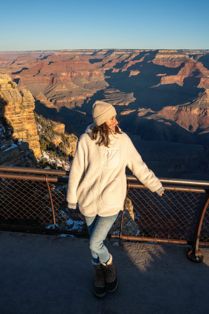 woman watching sunrise at the Grand Canyon