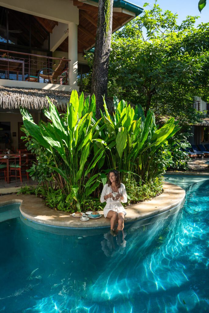 woman having breakfast by the pool at the best hotels in nosara costa rica