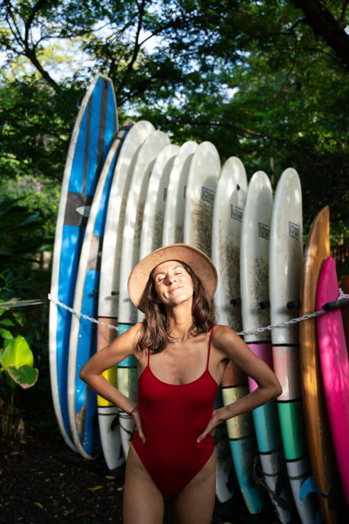 woman in front of surfboards