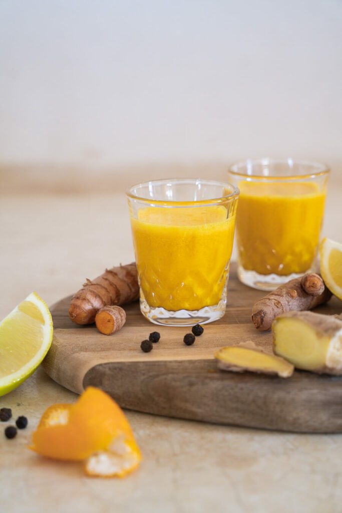 two ginger turmeric shots in glasses
