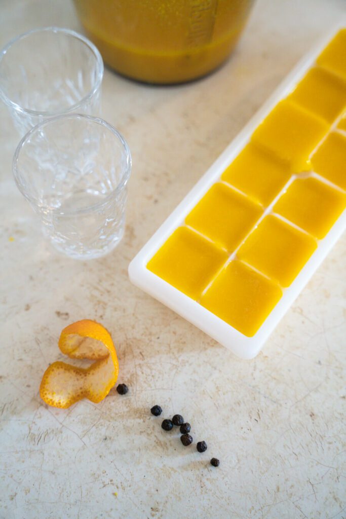 ginger turmeric shot in ice tray ready to freeze