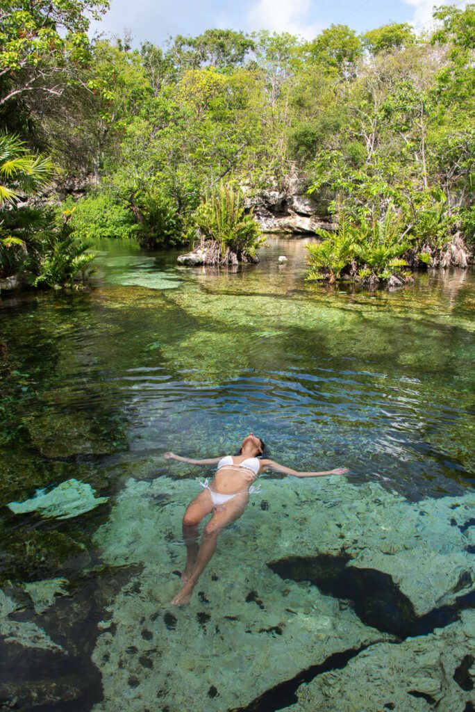 woman swimming at cenote azul