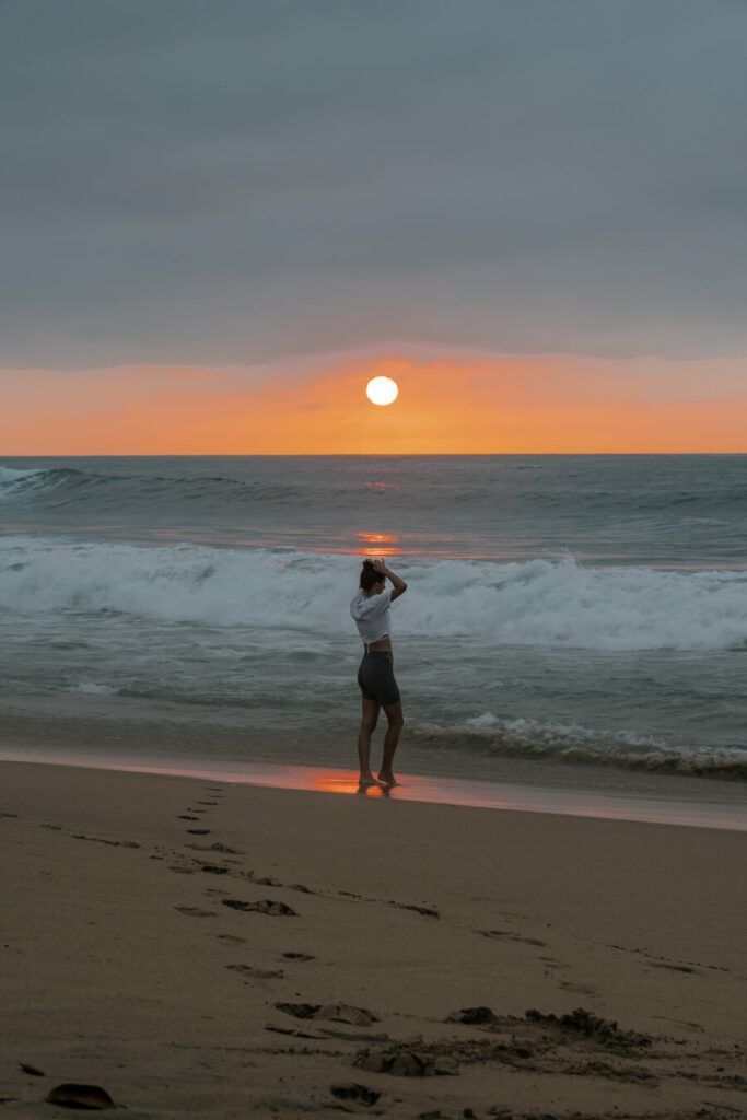 woman enjoy a sunset on the beach in mexico
