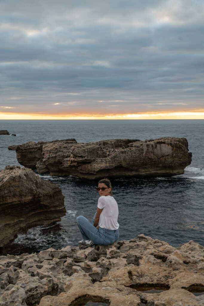 woman watching the sunset at Dwejra Bay Gozo island