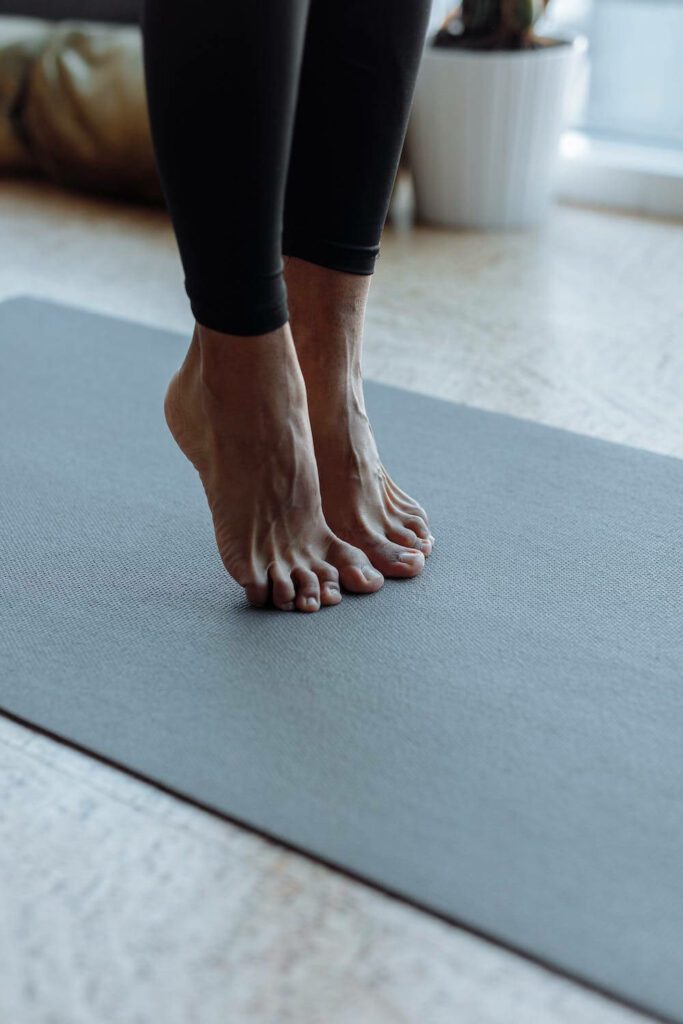 feet on a yoga mat while doing yoga