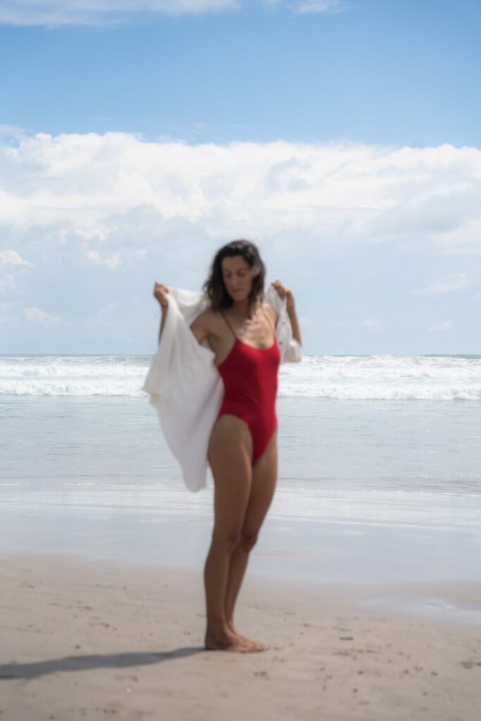 woman in swimsuit on santa teresa beach, costa rica