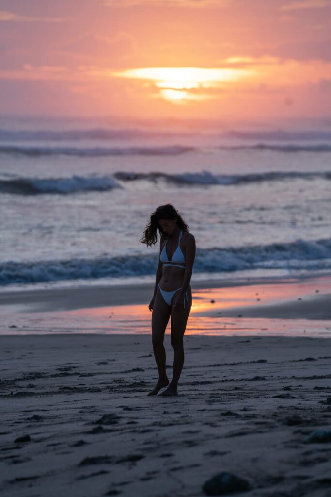 woman during sunset of santa teresa beach costa rica