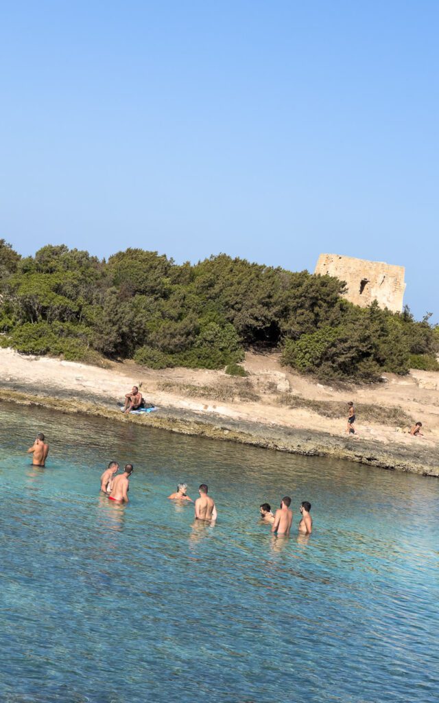men bathing in a beach in Ostuni