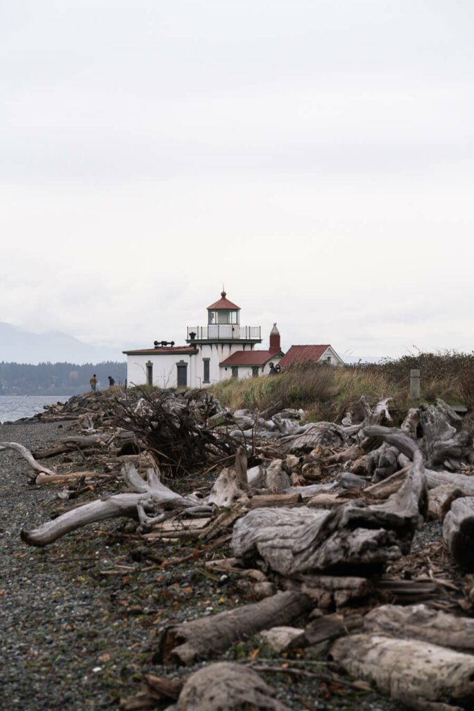 Discovery Park lighthouse with logs on a cloudy day