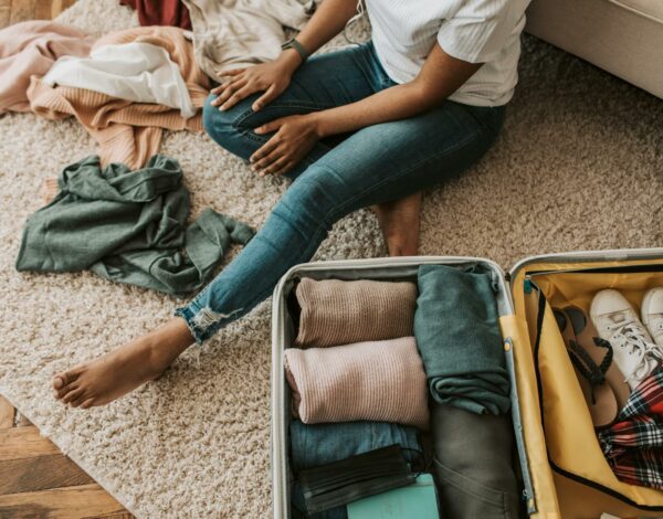 a woman packing her suitcase