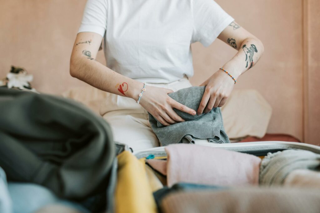 woman folding clothes for a wellness retreat