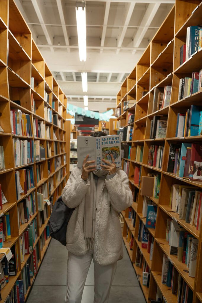 woman with book at a book store in Portland OR