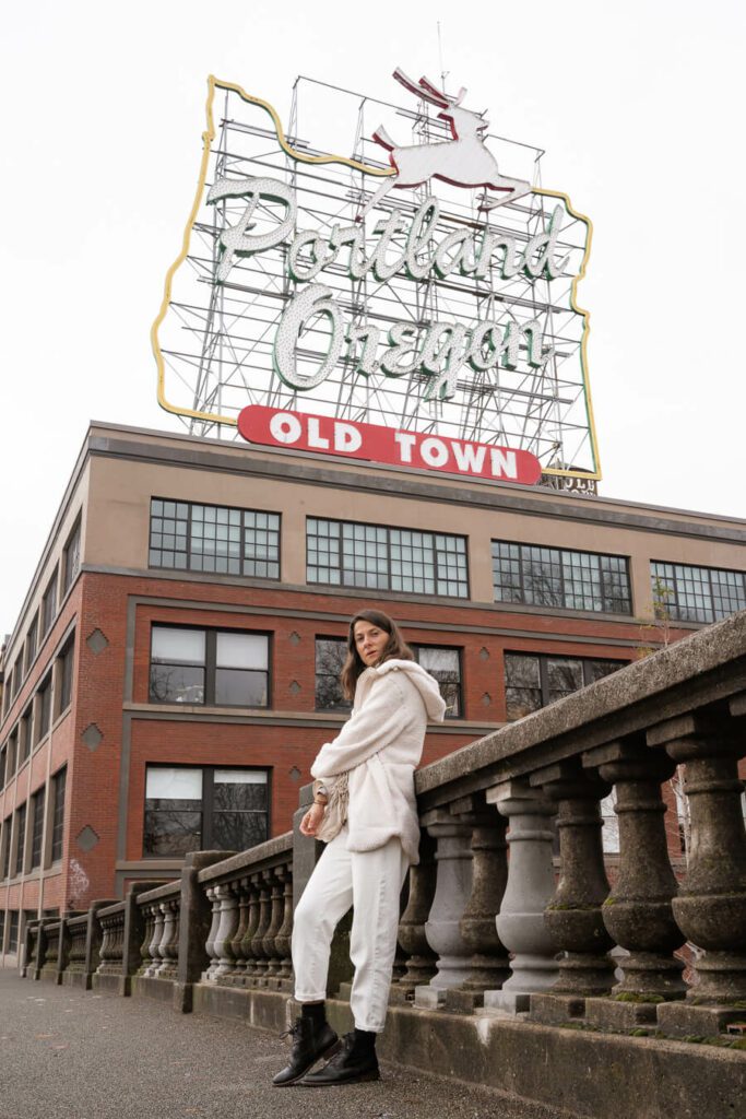 woman infront of Portland Oregon Old Town Sign