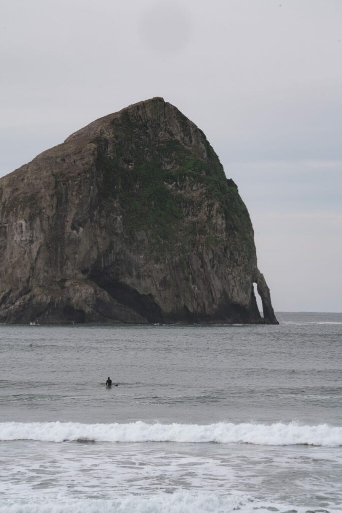 sea stack and surfer on the north oregon coast