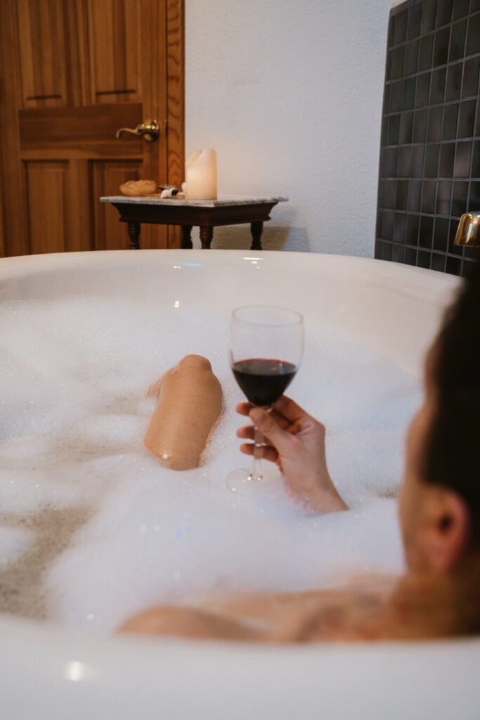 woman drinking wine in the bath