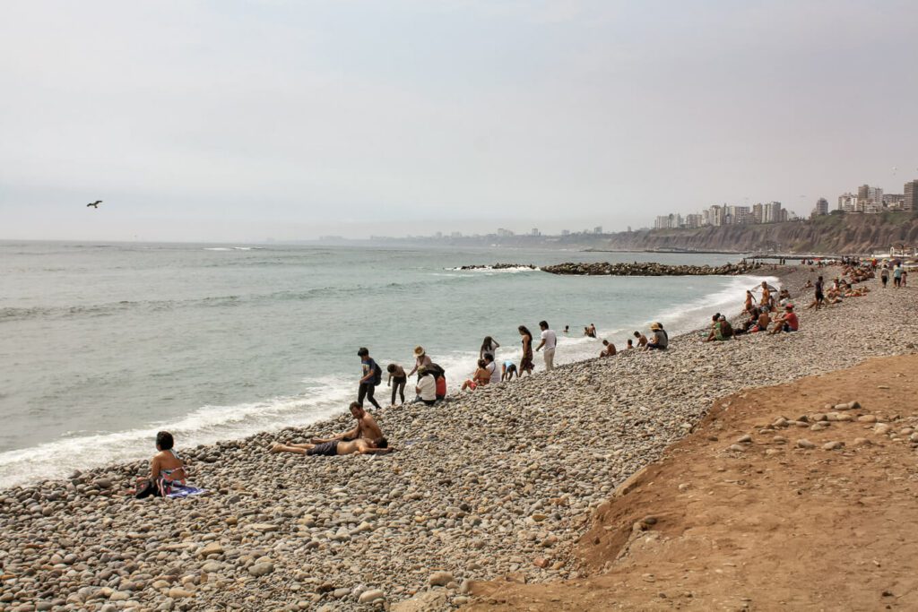 people on the beach in lima peru