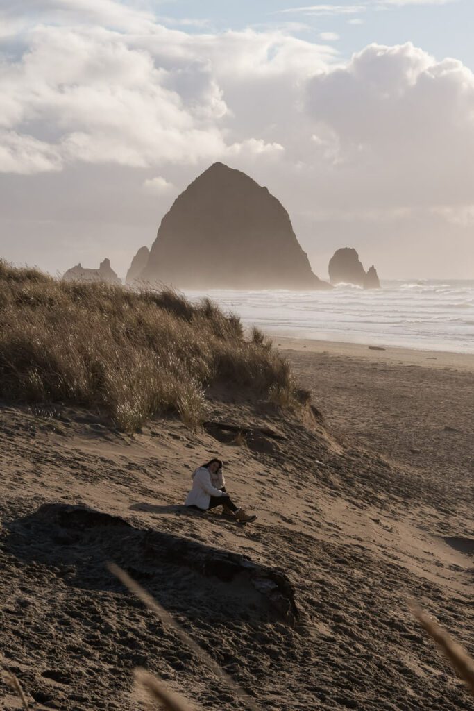 woman on cannon beach with haystack rock view