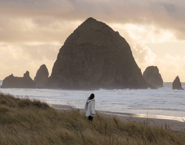 woman in front of haystack rock cannon beach or